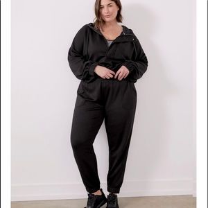 Black joggers with tie and elastic on waistband and ankles.